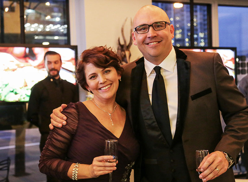 Amie, a happy event client who hosted a viewing party for The Oscars, posing with a Champaign glass.