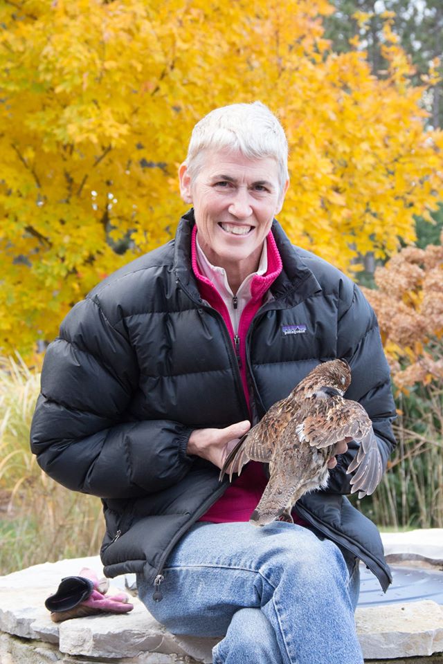 Kris, a happy travel client, posing with a falcon.