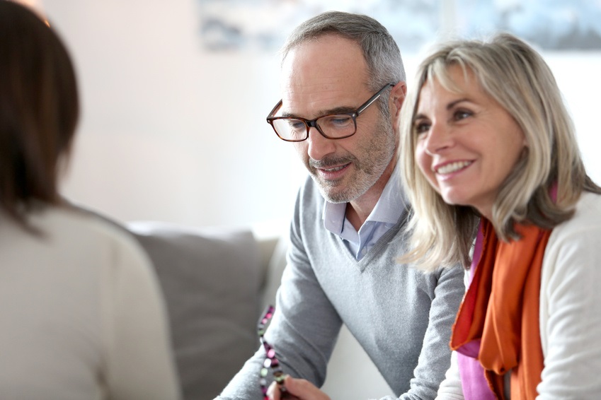 Senior couple meeting a travel advisor for luxury travel options.