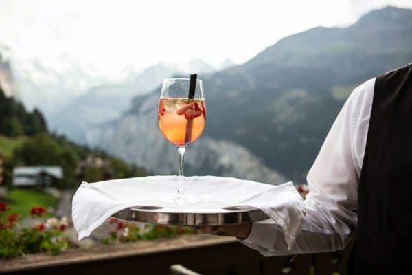 Server carrying a wine glass