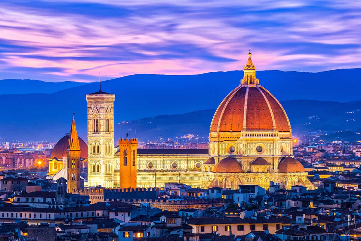 Florence Duomo Sunset Bright lights illuminate the Duomo as dusk falls on Florence, Italy.