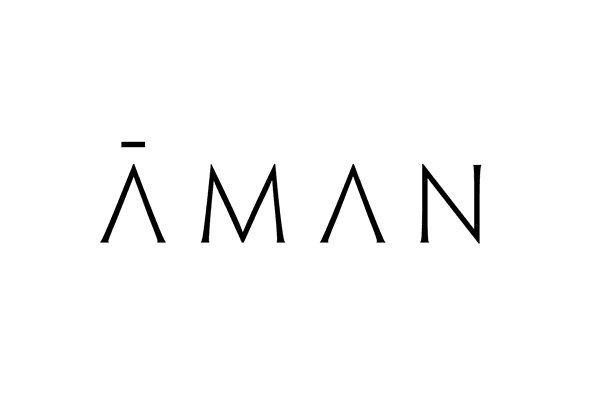 The text "ĀMAN" is displayed with stylized lettering, accompanied by a horizontal line above a single character.