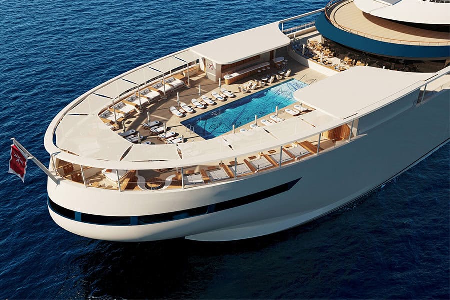 Four Seasons Yacht Aerial view of a luxury yacht featuring a spacious deck with a swimming pool, sun loungers, and an outdoor bar area, surrounded by deep blue ocean water.